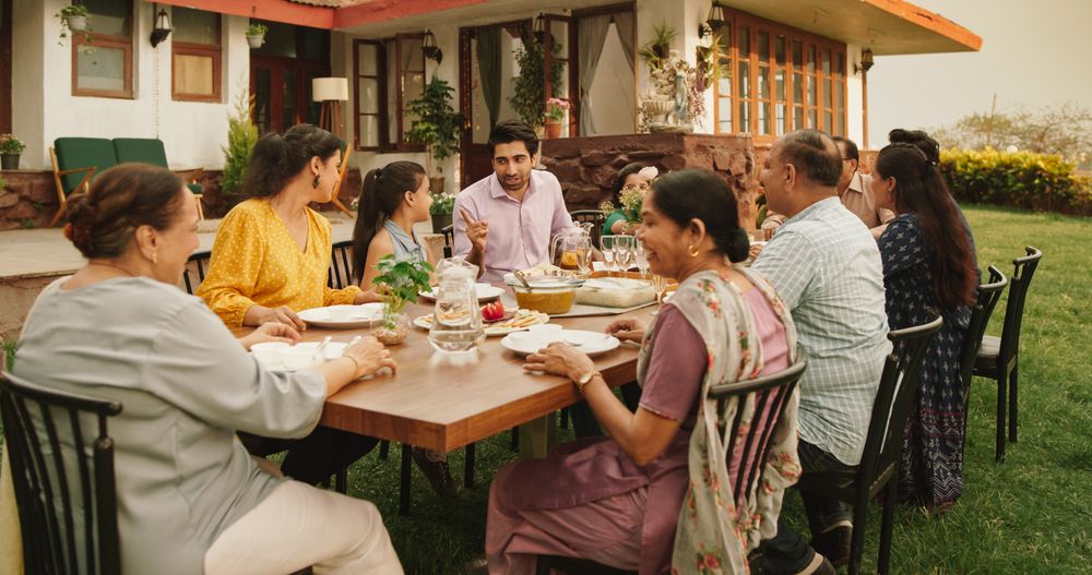 Indian Family Gathering Portrait: Family and Friends Celebrating Outside at Home.
