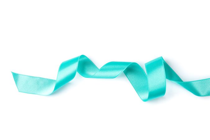 Turquoise ribbon isolated on plain background. Gift concept