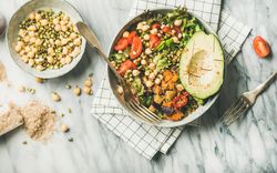 Healthy vegan lunch bowl with avocado, sprouted grains, vegetables,  horizontal composition
