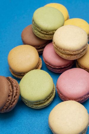 Pile of French pastel macaroons on a blue table