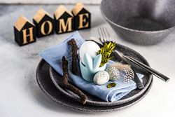 Easter table setting with eggs, branch and feather