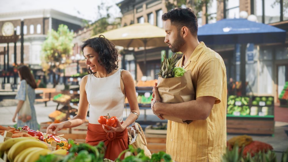Multiethnic Couple Shopping for Fresh Seasonal Fruits and Vegetables for a Delicious Summer Dinner.
