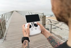 Man with remote for drone on film set