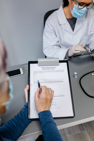 Woman reading consent form for coronavirus vaccine