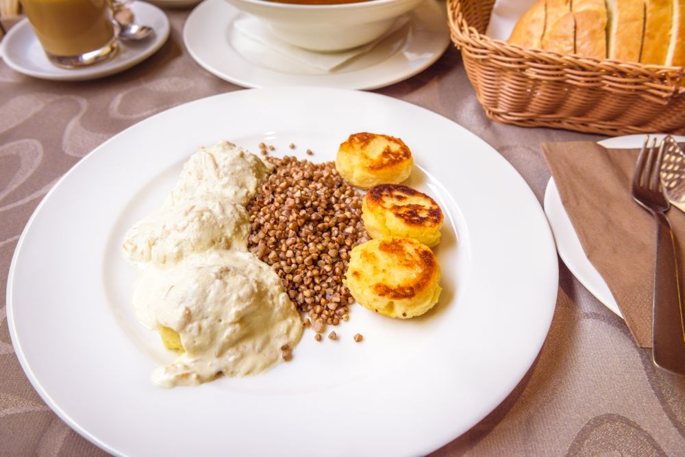 Boiled potato dumplings with onions and cream