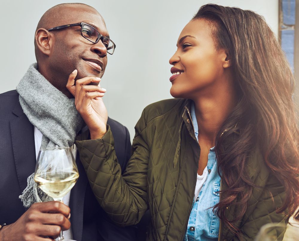 Woman lovingly holding a man’s chin in her hand