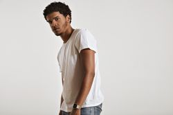 Portrait of man looking to the camera from the side in studio shoot
