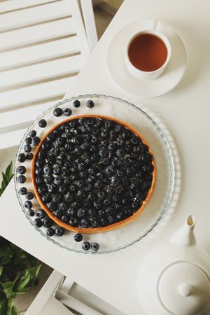 Concept of tasty breakfast with blueberry pie on table