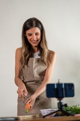 Young woman chopping fresh vegetables for a healthy recipe tutorial