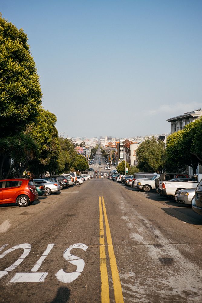 View from center of street of cars parks on either side