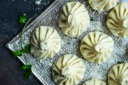 Top view of trey of Georgian khinkali dumplings with cilantro