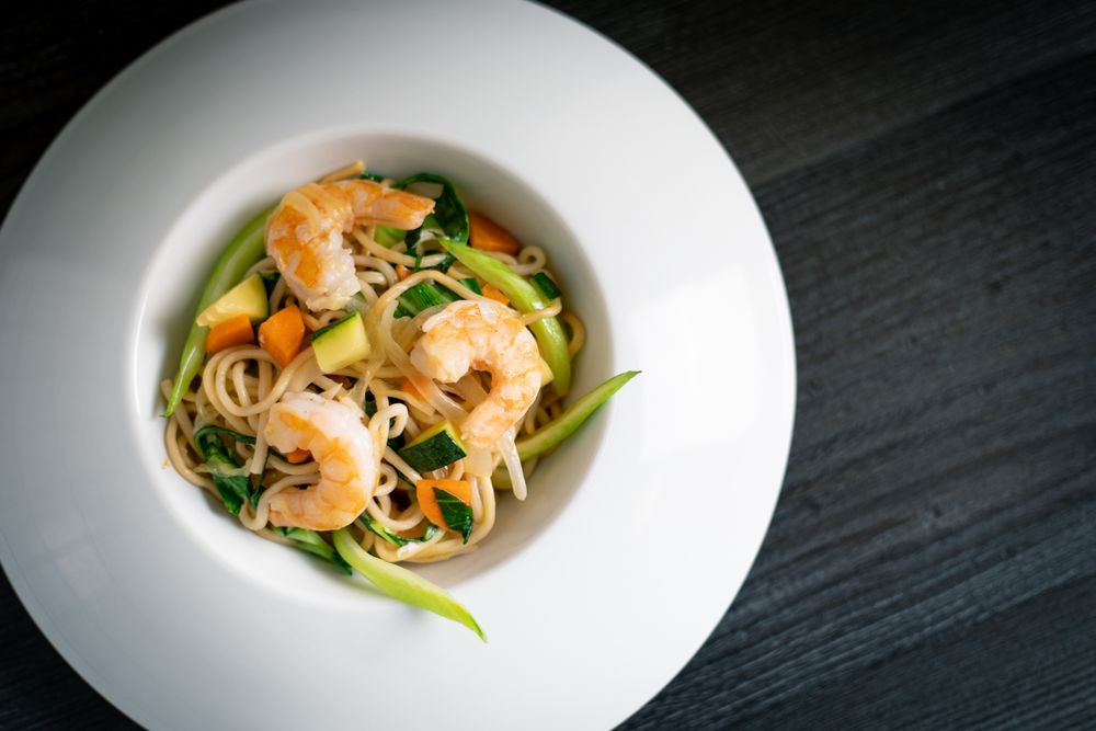 Tasty Pad Thai of vegetables and prawns in plate