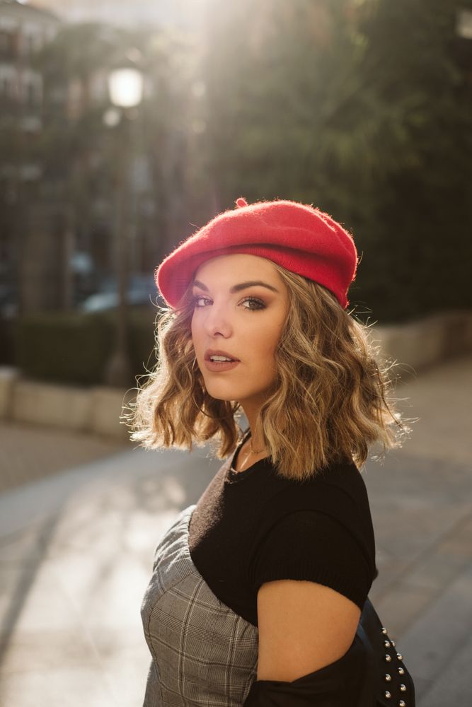 Stylish female in beret looking at camera