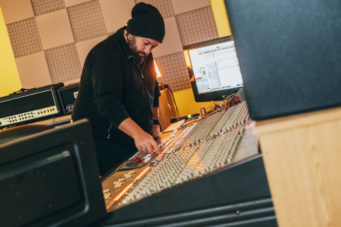 Man in a equalizer instrument in a studio