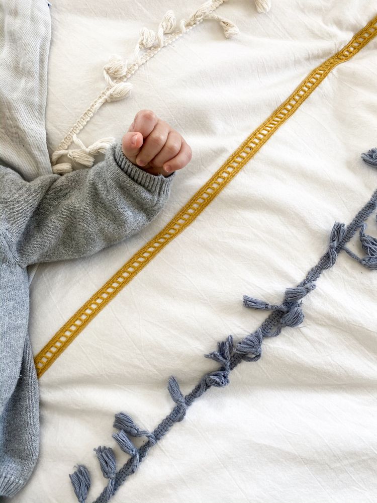 Baby lying on bed