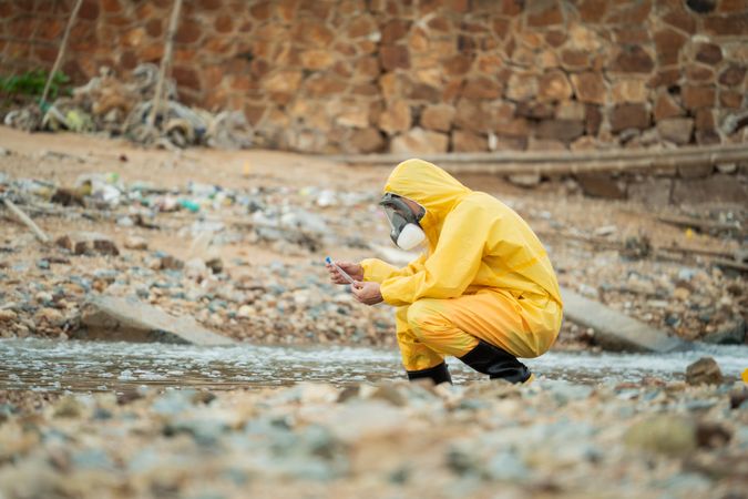Environment scientist analysing waste water and collecting sample for research