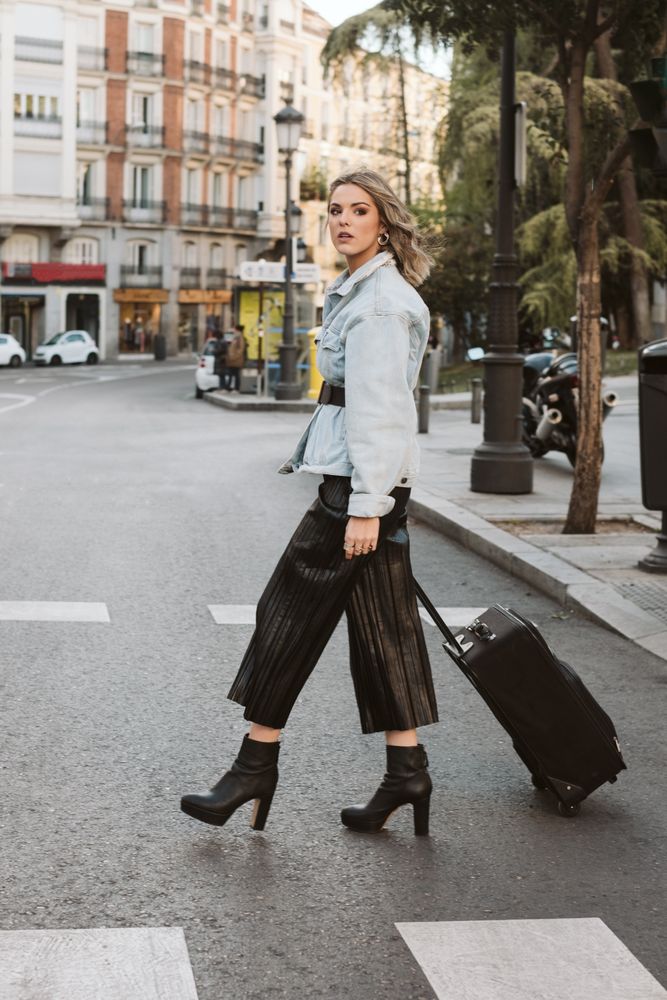Cheerful female tourist crossing street