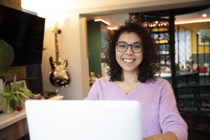 Woman smiling and using laptop