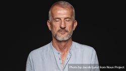Portrait of man with gray hair against dark background 0PkeNb