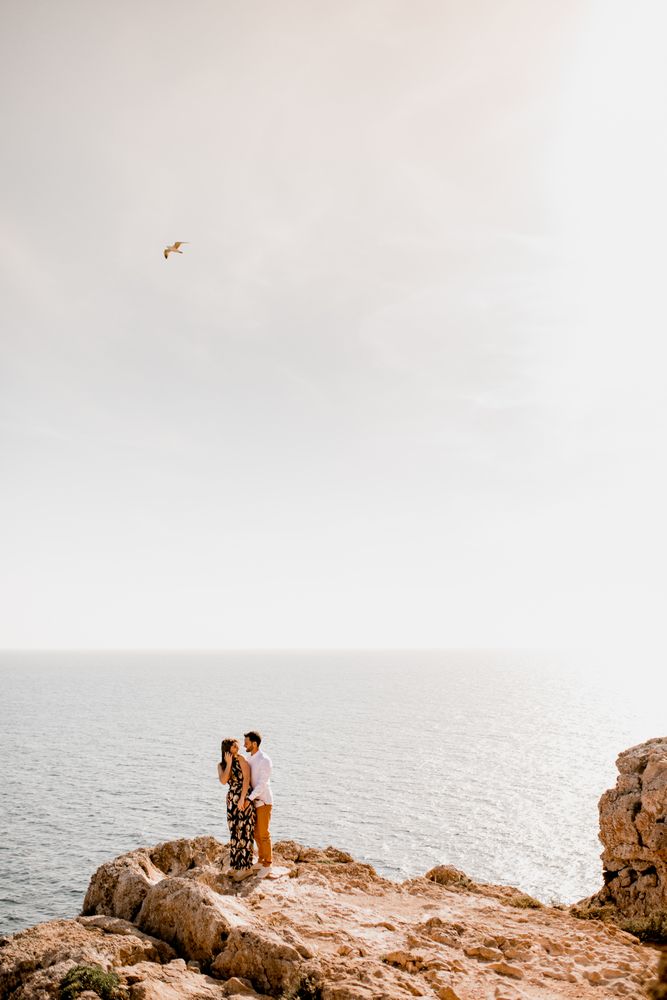Couple embracing on rock