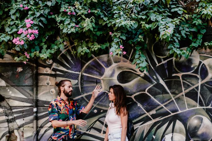 Casual friends against wall with graffiti