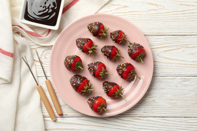 Chocolate fondue. Strawberry in chocolate on wooden background