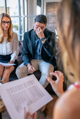 Tired businessman rubbing his eyes