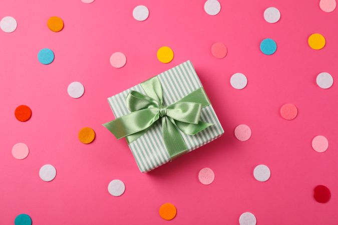 Gift box with bow on pink background, space for text
