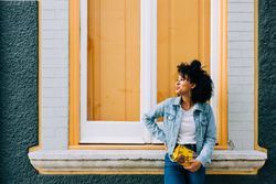 Smiling Black female by yellow window