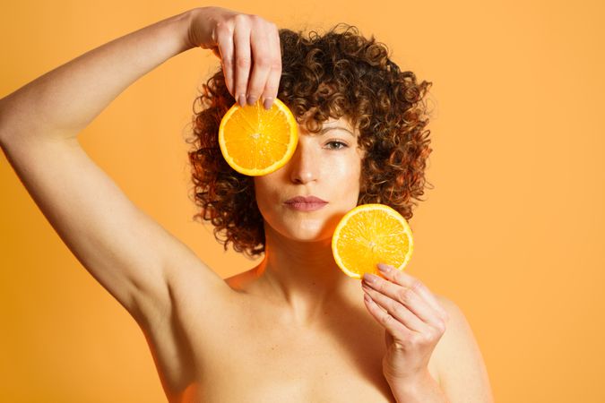Woman in orange studio with orange slices