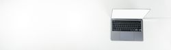 Top view banner of opened silver laptop and keyboard on bright desk with copy space