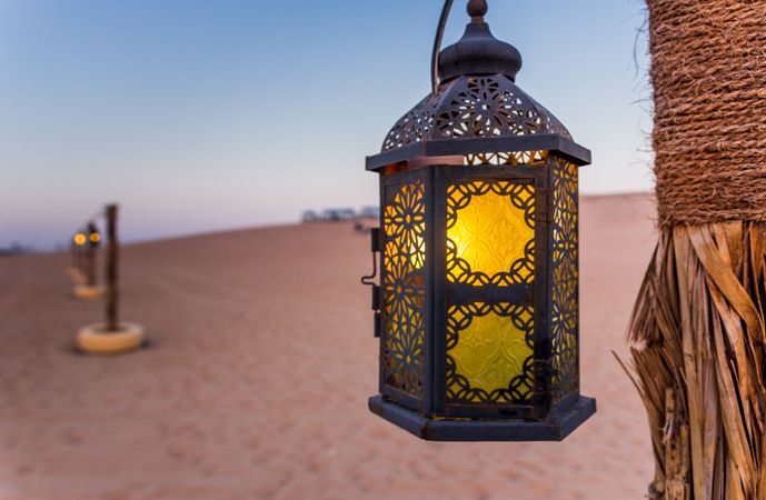 Poles with lanterns in desert