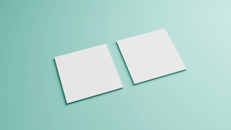 Square paper cards on mint green background, copy space