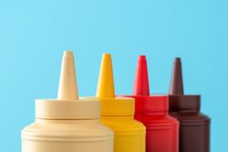 Sauce bottles close up on a blue background
