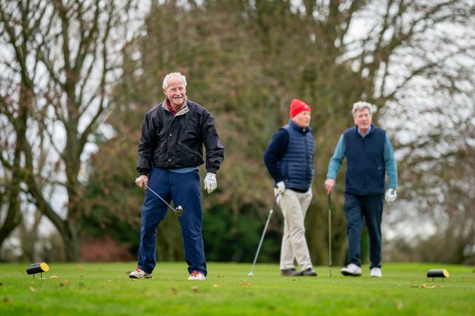 Man satisfied with shot on golf course