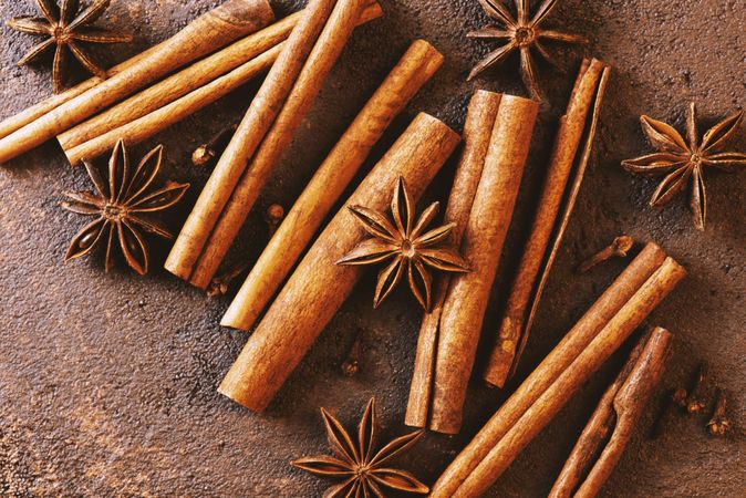 Cinnamon sticks and anise on brown background