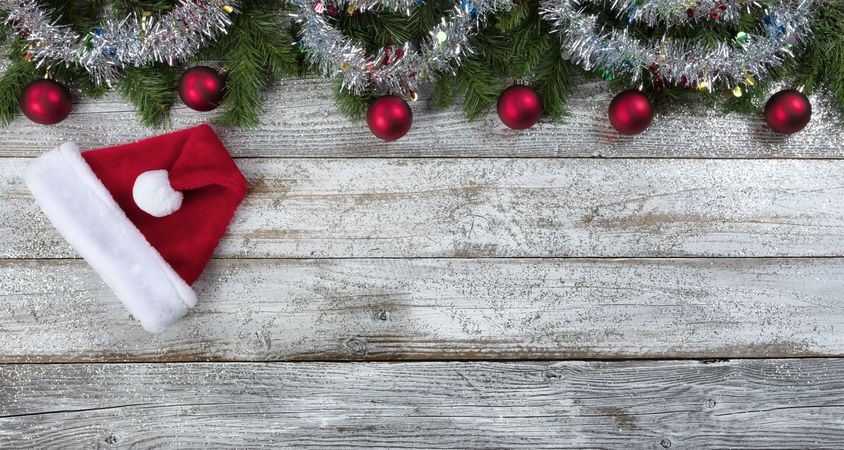 Christmas or New Year holiday background on aged wood with Santa hat