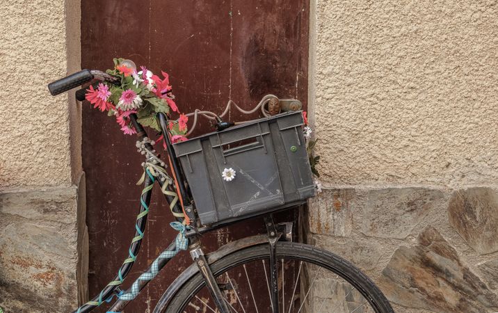 Plastic basket attached to decorative bike