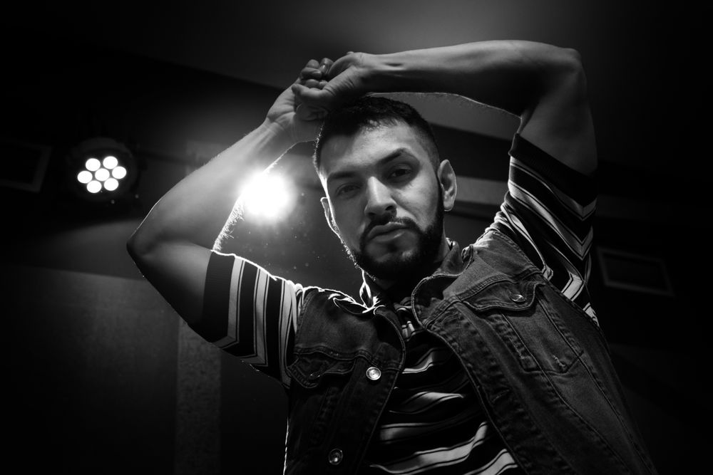 bearded man dancing in spotlight