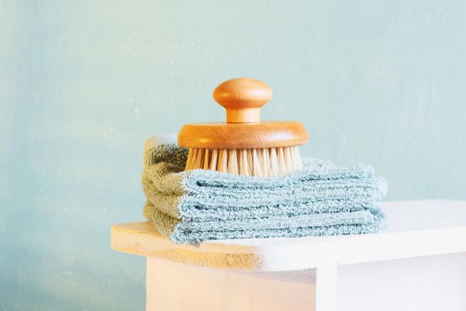 Bathing brush on stack of hand towels