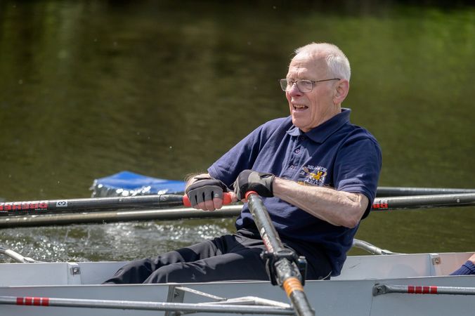 Older man rowing in river