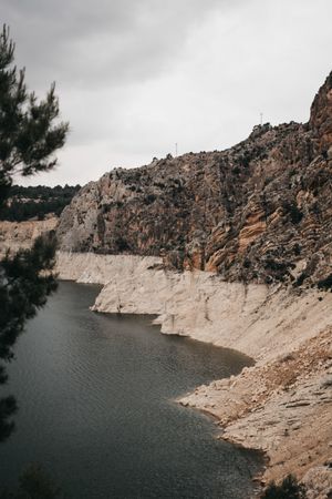 Rough cliff near calm water