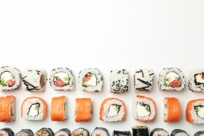 Flat lay with sushi rolls on blank background. Japanese food