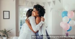Pregnant woman hugging a friend at baby shower 5pgPey