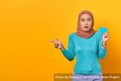Muslim woman looking surprised with credit card 0gexA4