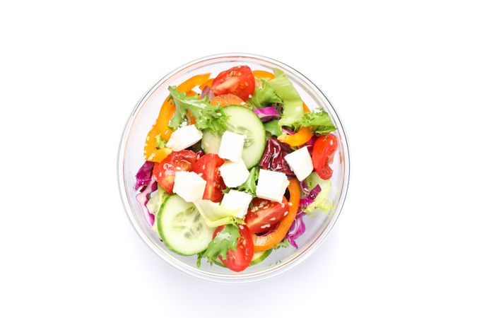 Glass bowl with fresh salad isolated on plain background