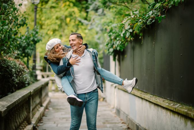 Happy couple having fun together at overgrown city street