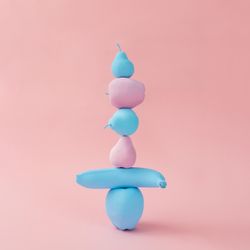 Stacked painted pink and blue fruits