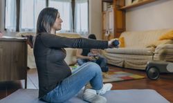 Pregnant woman exercising in the living room