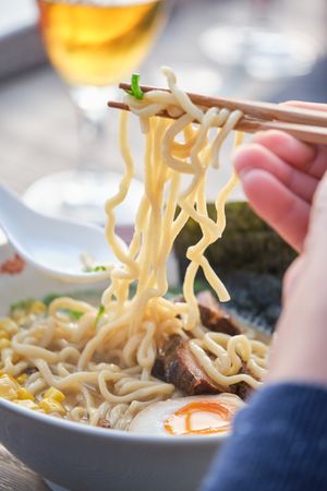 Faceless Client Eating Ramen Soup